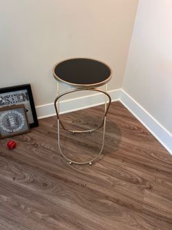 Gold table with dark glass