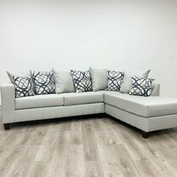 New light grey sectional with pillows 