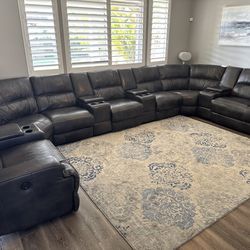 Full black grey sectional with 5 motorized recliners and rug