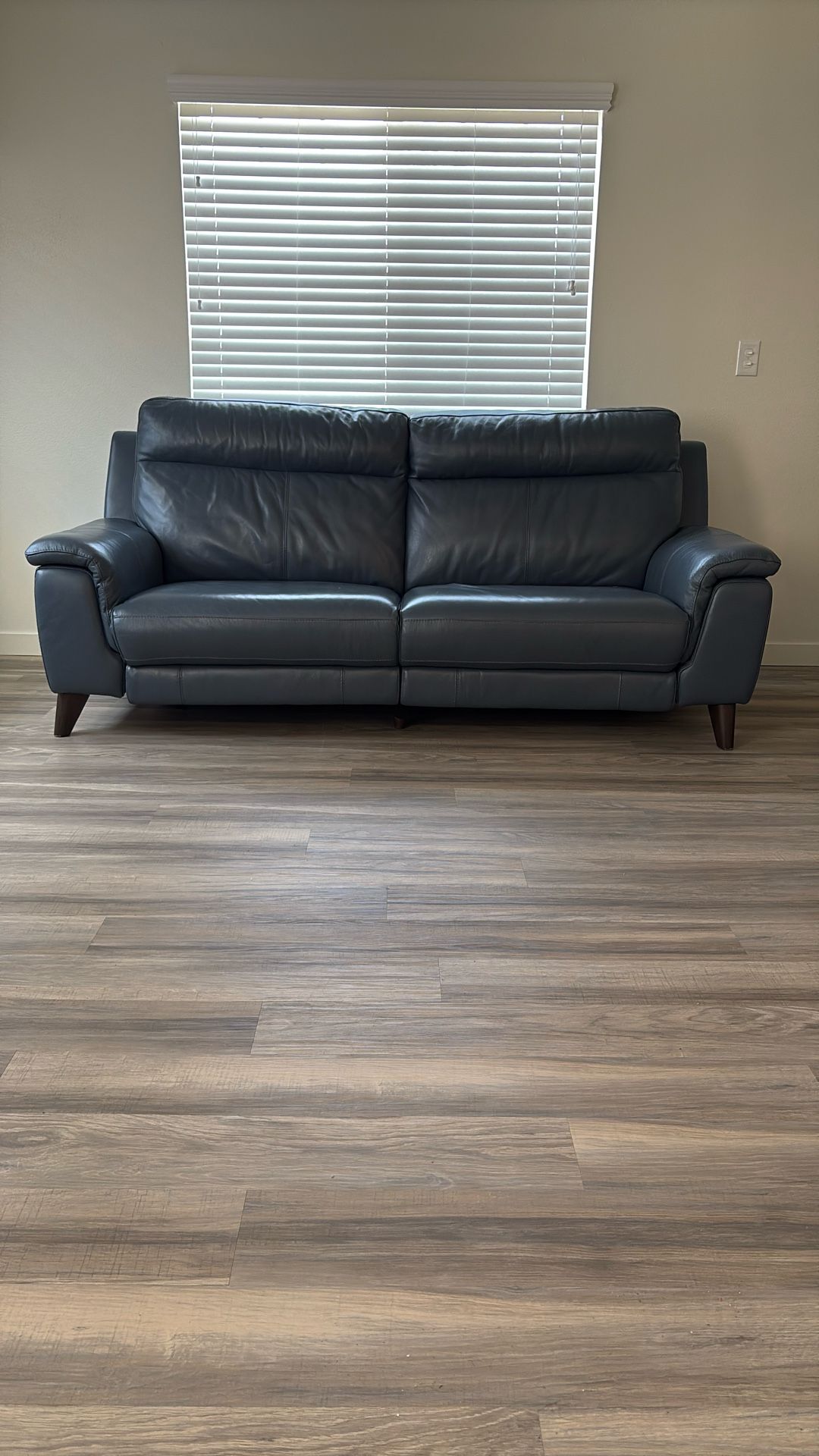 Blue 87 Inch Reclining Leather Sofa In Great Conditions.