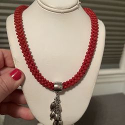 Beautiful choker necklace, beaded with tassel. Stamped silver. The color is red looks beautiful on. Freshly cleaned 