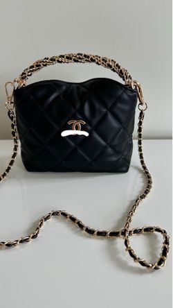 Black handbag with gold chain