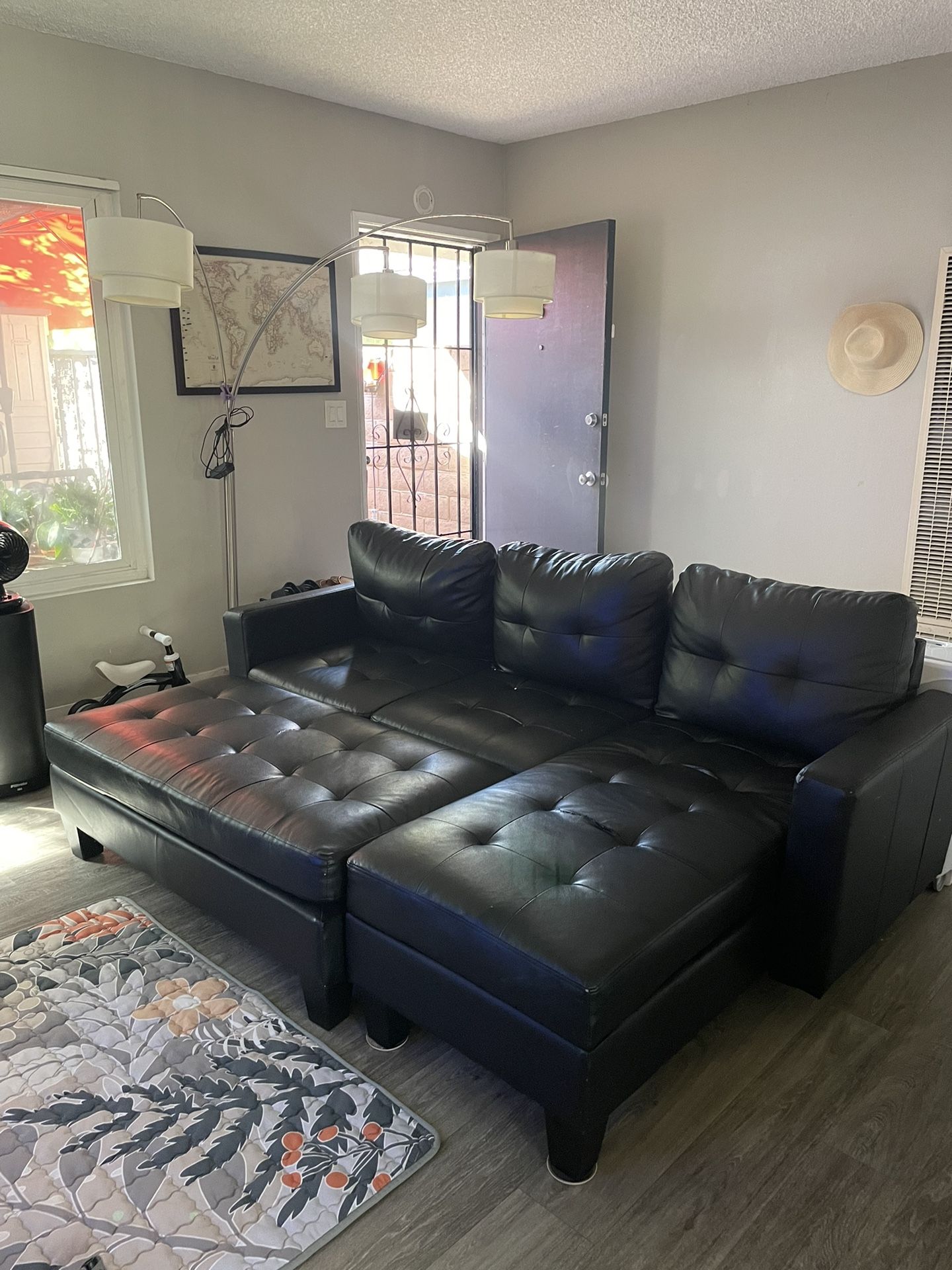 Small sectional sofa with ottoman.