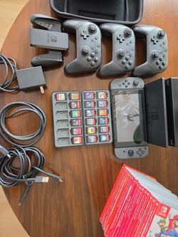 Nintendo Switch with controllers, travel case and 19 Game Cartridges