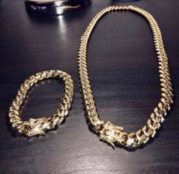New 14 k yellow gold Cuban link chain and bracelet