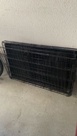 Lightly used metal dog crate medium sized