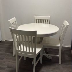 white round table and white chairs (please buy)
