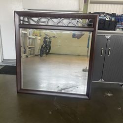 LARGE FRAMED DESIGNER SOLID WOOD MIRROR. NEW.  40 INCHES WIDE AND 43 INCHES HIGH. DARK BROWN