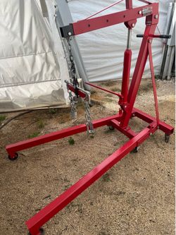Engine hoist with load leveler.