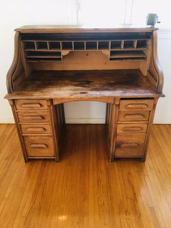Antique wood writer’s desk with cubby slots and ample drawer space