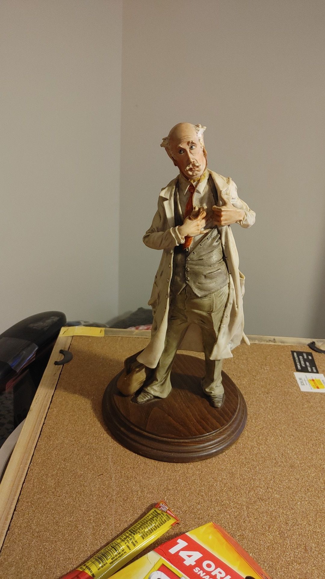 Vintage statue of elderly Dr. With stethoscope and bag on wooden base