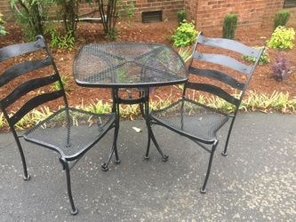 Vintage iron table Two chairs Space for umbrella