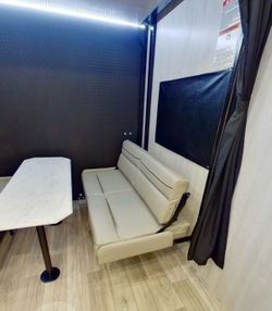 Rv toy hauler dinette foldable sofas.