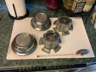 vintage center cap for a Chevrolet Monte Carlo, 2 of them likely fitting models from 1973–1977.The cap is made of metal and features the iconic Chevro