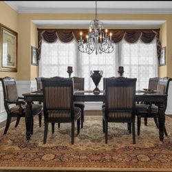 LAST CHANCE MOVING THIS SUNDAY Elegant Dining Table Set  with eight chairs, a buffet hutch, and a mirror with ornate wood work