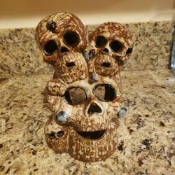 Ceramic candle holder with 6 skulls and a spider