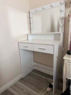 White vanity and mirror with lights