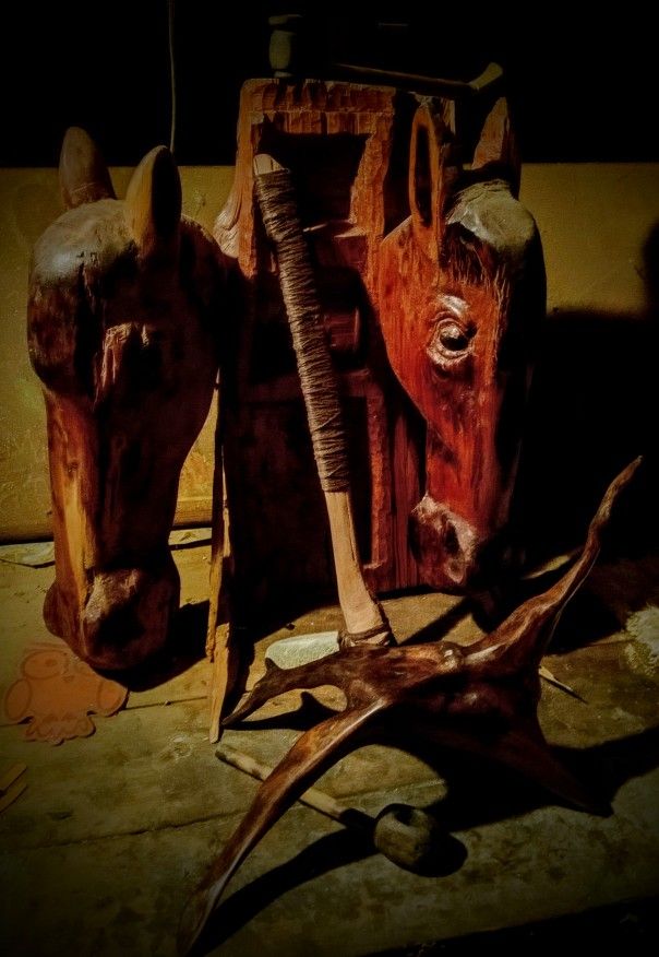 A Pair Of Two Horse Head Carvings