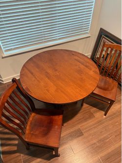 Amish made dining table and two chairs.