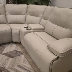 Right-Facing cream faux leather sectional.