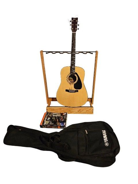 YAMAHA ACOUSTIC GUITAR WITH YAMAHA CASE AND MANY EXTRAS INCLUDING BRAND NEW CHORD BUDDY IN BOX, GUITAR STRING SWING GUITARS STAND, CAPO AND GUITAR TUN