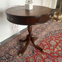 Solid mahogany 28 inch round table with drawer and brass accents.