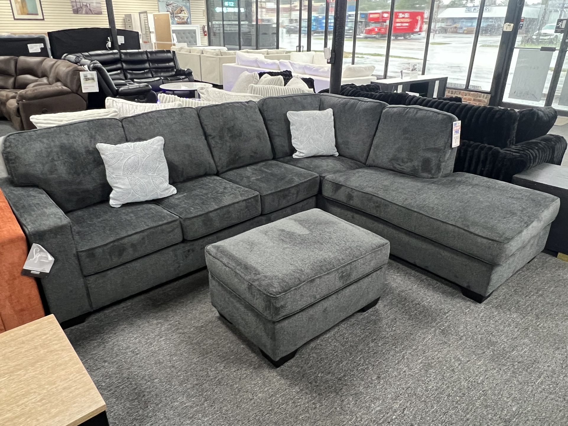 New Dark Gray Sectional By Ashley. Ottoman $199 More. Delivery & Set Up Available