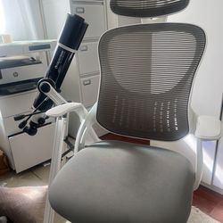 white and gray swivel desk chair with back and neck support