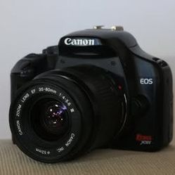Canon EOS Rebel XSi Digital SLR Camera +Canon 35-80mm F/1:4-5.6 III lens +a battery +charger +SD card (Works perfectly. Rarely used. Good condition)