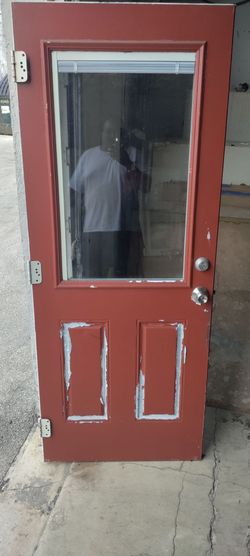 Exterior half-view with inner blinds metal door approximately 32x79