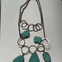 multi-strand necklace with turquoise stones and brass-toned links.