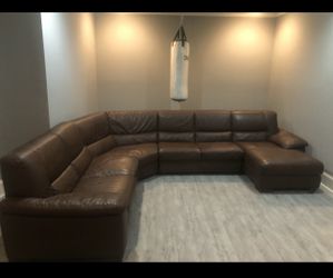 Like new beautiful real leather sectional with Ottoman