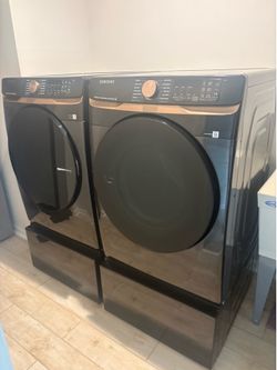 Samsung Extra Capacity Smart Large Front Load Wash & Gas Dryer Set  with Steam Sanitize+ and Sensor Dry in Brush Black with Bespoke 27” Pedestals