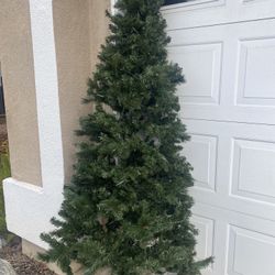 Selling A 7.5 ft Artificial  Christmas Tree With pre lite white Lights in working condition, still in good condition,  needs tree stand 