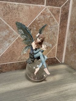 Fairy Figurine Sitting on Crystal Ball