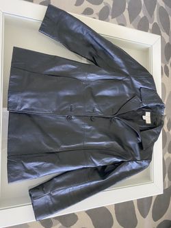 Women’s black leather jacket and purse