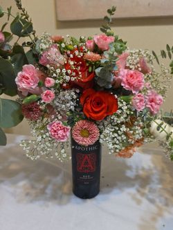 Bottle and Pumpkin Floral Arrangement.