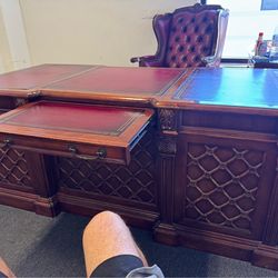 Complete office suite, one executive desk one roll top desk, solid mahogany and burgundy leather. Cost $25,000 must sell quick $1950.