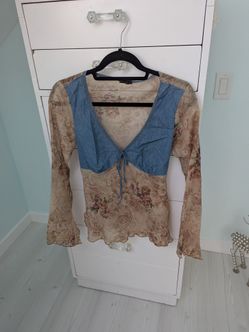 Woman's flowy blouse all sheer except where the denim is. Looks to be maybe a medium