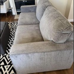 Gray loveseat with queen couch bed