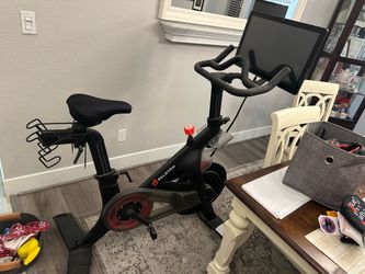 Peloton bike, two pairs of shoes