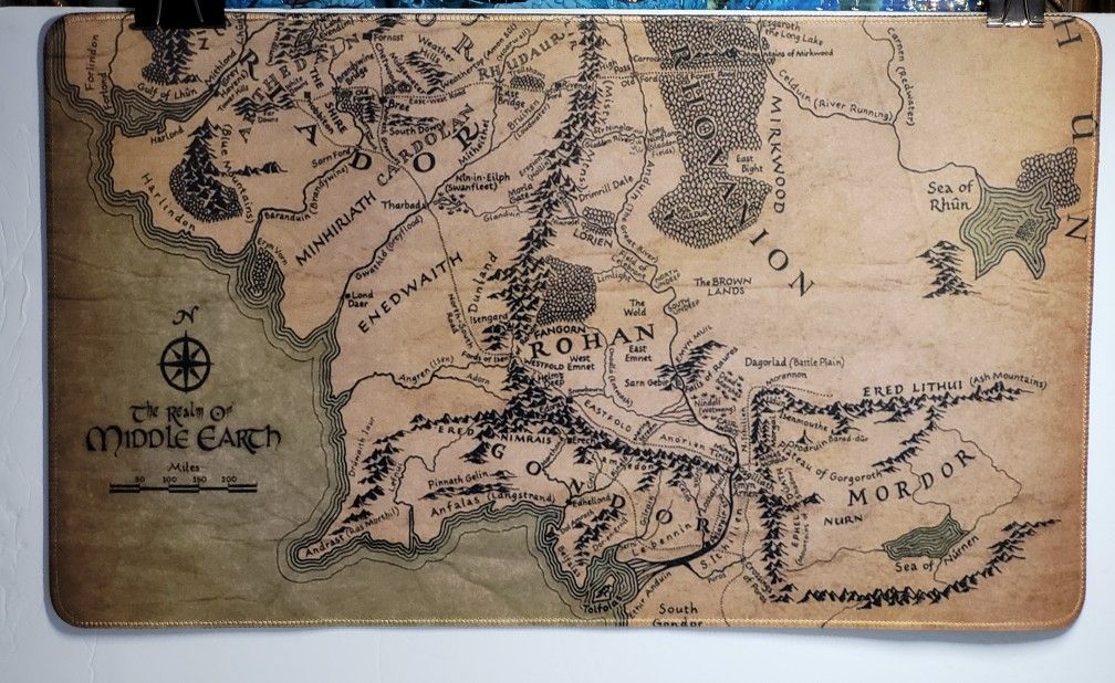 XL 14 X 23.5" Middle Earth Brown Map Lord Of The Rings Desk Mat Gaming Mouse Pad Open Package. The image shows an XL mouse pad featuring a map of Midd