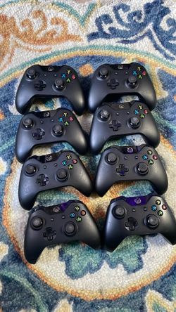 8 black xbox controllers