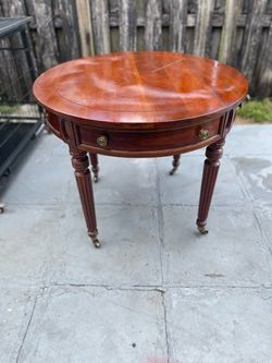Henredon Circular Cherry Wood Center Table with Sectioned Top, One Drawer in the Front and Three False Drawers In the Round, on Turned Fluted Tapered