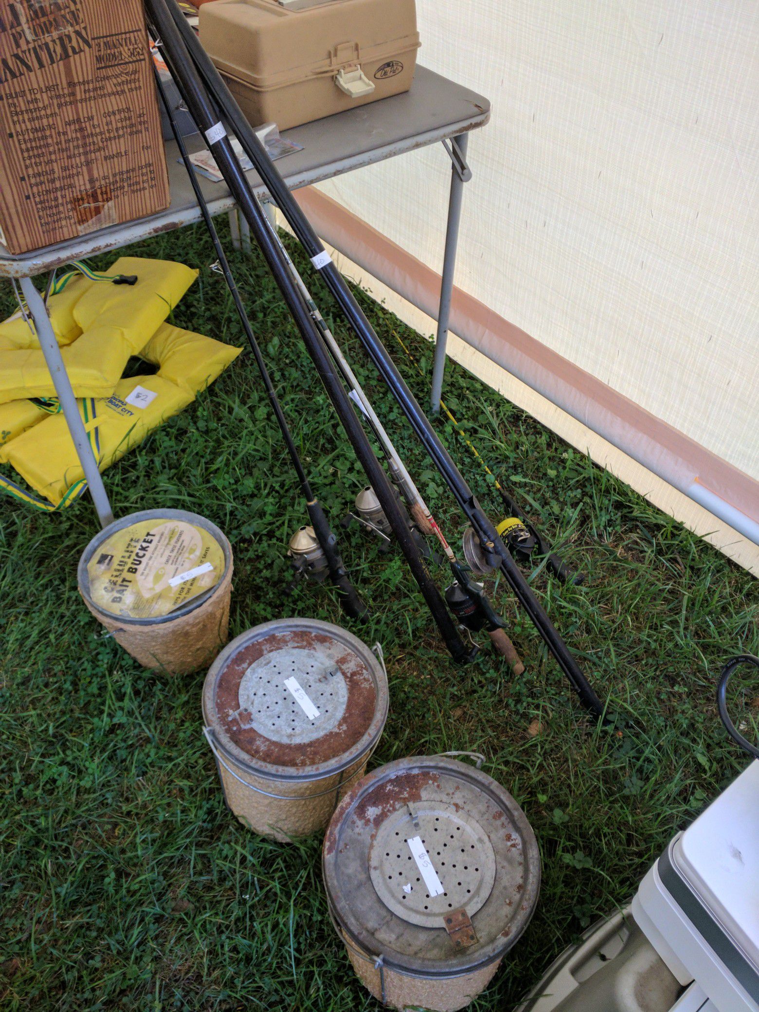 Vintage Bamboo fishing poles, bait tubs and more