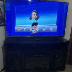 Selling 65” LG 4K UHD Smart TV with fireplace TV stand