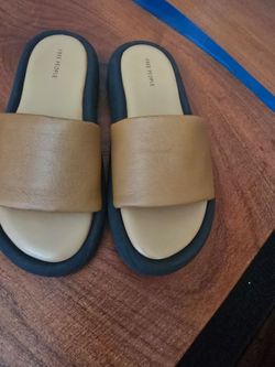 Minimal  free people  slide sandals with a wide cognac leather strap. Padded tan footbed and contrasting black sole. Sleek, casual style for everyday