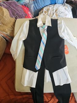 Wonder Nation boys' formal suit set includes a black vest, white button-down shirt, matching black pants, and a striped blue and gray tie.