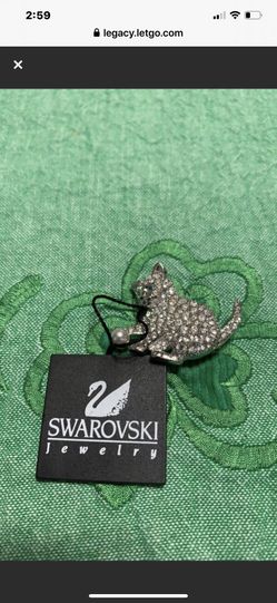 NWT Swarovski cat pin with green eyes and a pearl ball
