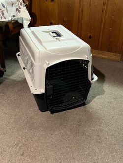 Carrier for small o medium dogs and cats (20-30 Ibs)—suitable for travel, air, road, or home use- 28" L x 20.5" W x 21.5" H, with steel door.